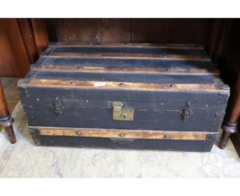 A vintage canvas and teak bound travelling trunk