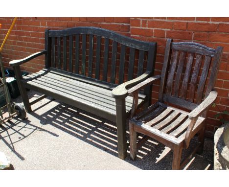 A stained teak garden bench and matching chair