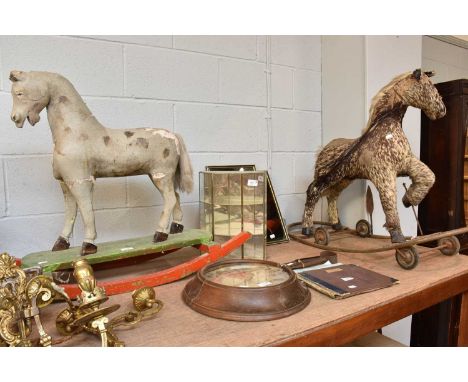 A Carved Pine Painted and Gesso Rocking Horse, a mid-20th century hide-mounted horse on a pull-along base (af), a synchronome