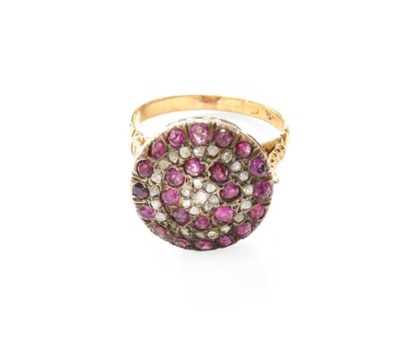 A Ruby and Diamond Cluster Ring, stamped ‘750’, finger size Q (a.f.)Gross weight 7.5 grams.