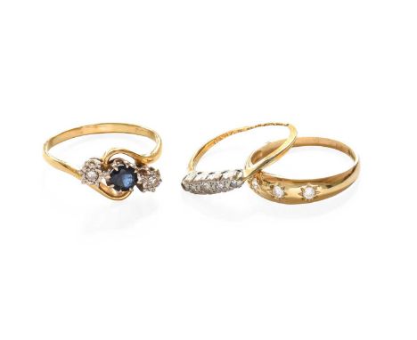 An 18 Carat Gold Sapphire and Diamond Three Stone Twist Ring, finger size Q; A 9 Carat Gold Cubic Zirconia Three Stone Ring, 