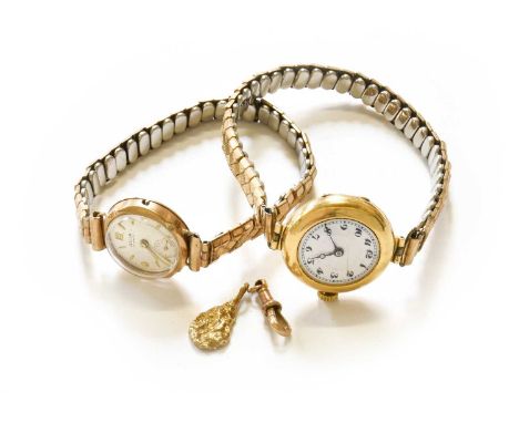 A 9 Carat Gold Pendant, length 2.1cm; A Clip Fastening, stamped '9C'; A Lady's 18 Carat Gold Enamel Dial Wristwatch and A Lad