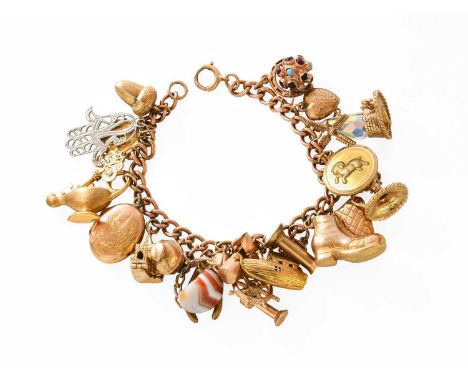 A Curb Link Bracelet, stamped '9' and '.375', suspending twenty-three charms including a boot, a windmill, a locket, an agate