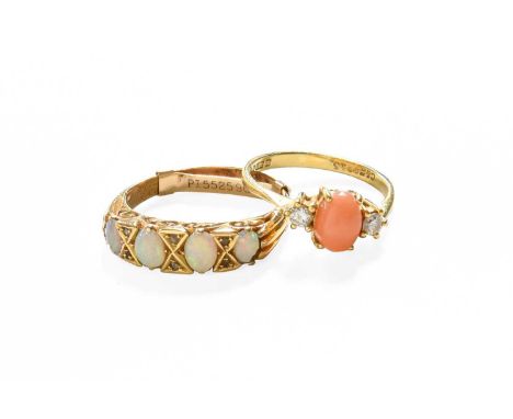 A 9 Carat Gold Coral and Diamond Three Stone Ring, the oval coral cabochon flanked by round brilliant cut diamonds in yellow 