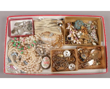 A tray of vintage costume jewellery including white paste, gilt chains and a collection of stick pins etc.  