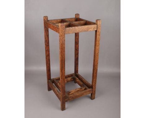 An Arts &amp; Crafts oak stick stand, 61cm high.  