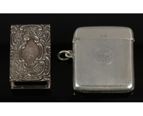 A George V silver vesta case with engine turned engraving, assayed Birmingham 1919.  Along with a silver match box case, assa