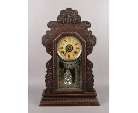 An Ansonia Clock company gingerbread automatic alarm clock with ting tang chime, 58cm.  