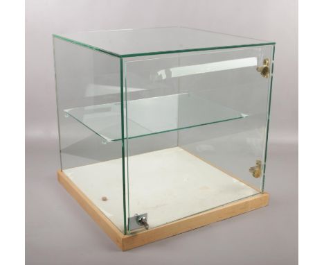 A lockable glass display case, with shelf to interior. (43.5cm x 44cm x 44cm)  