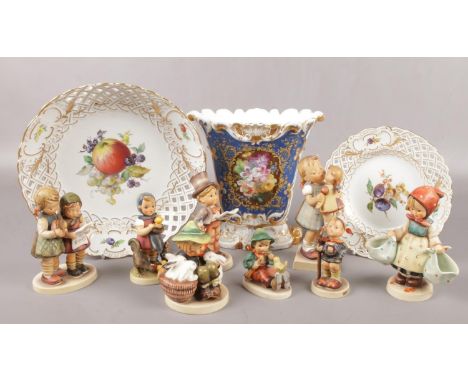 A collection of Goebel Hummel figures, along with two Meissen hand painted cabinet plates and a Continental vase.  