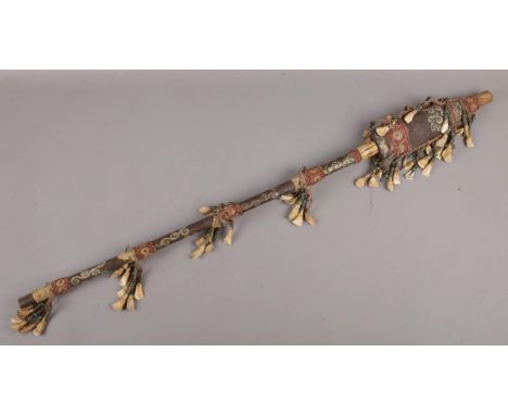 An African tribal witch doctor stick, with animal tooth and pigment decoration. (Length 94cm).  