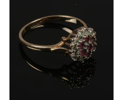 A 9ct gold ruby and diamond cluster ring, size P.  