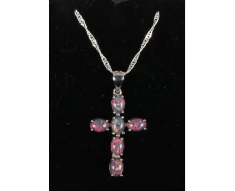 A silver and opal triplet cross pendant on silver twist chain.  