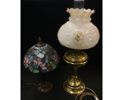 A Tiffany style leaded glass table lamp, the shade with dragonflies amongst lilies 37cm tall;  a brass electric lamp in the f