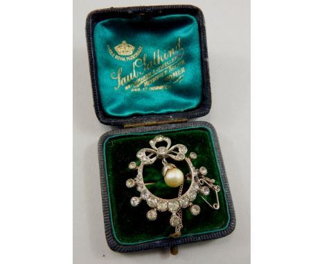 A Victorian silver costume brooch, in a circular shape, set with white paste stones, and with bow design to top, with culture