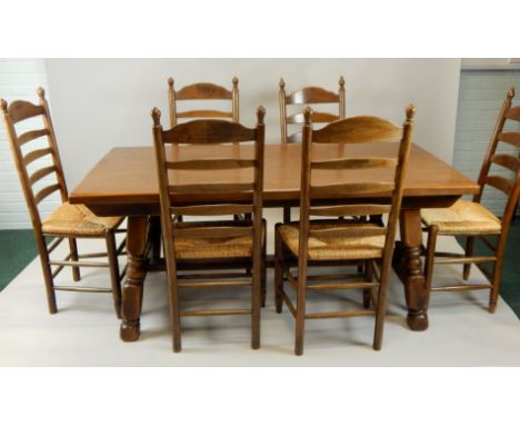 A reproduction oak refectory type dining table, and six ladder back chairs.