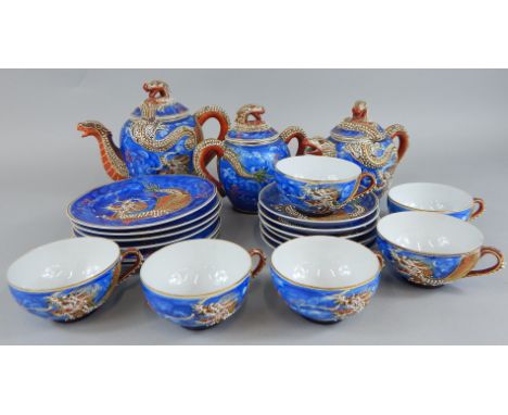 A mid 20thC Japanese egg shell porcelain part tea service, the cups with lithophane panels of Geisha etC