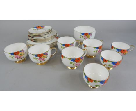 A Carlton china part tea service, hand painted with summer flowers in red, green and yellow, on a gilt lined white base, to i