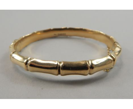 A 9ct gold bangle, of formed and braked design, 12.9g.