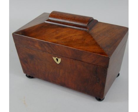 A Victorian sarcophagus shaped mahogany tea caddy, the interior with two later lidded divisions, 23cm wide