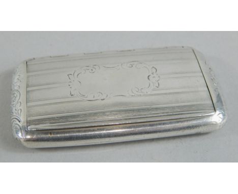 A rectangular Victorian silver snuff box, with engine turned decoration and central scroll engraved cartouche, with gilt inte