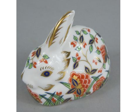 A Royal Crown Derby porcelain meadow rabbit, printed mark in red to underside and gold button