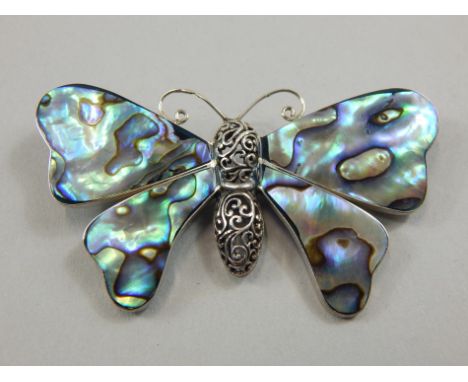 A silver and mother of pearl butterfly brooch, unmarked, 7cm wide. 