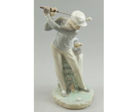 A Lladro porcelain figure modelled with a golfer taking a shot, 28.5cm high