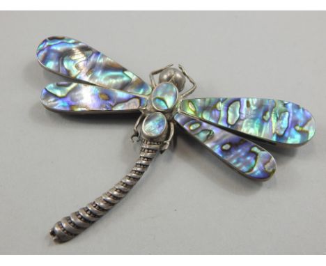 A silver and mother of pearl dragonfly brooch, unmarked, 10cm wide. 