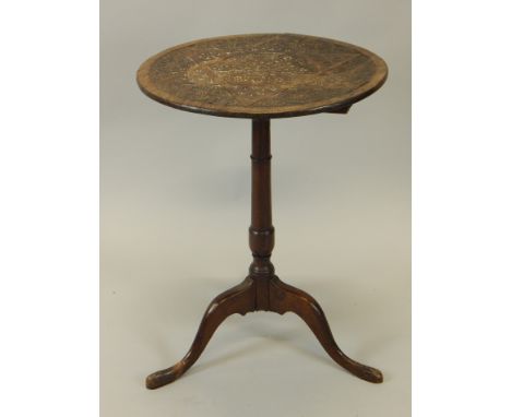 A Victorian oak occasional table, the circular top carved with roundels and a stylised star, on a turned columns, tripod base