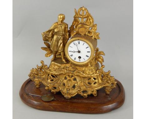 A late 19thC French gilt metal mantel timepiece, mounted with a bearded figure with a sword etC, beside the white enamel dial
