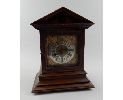 A late 19thC German mantel clock, in an oak case, the movement stamped Jungans, 33cm high