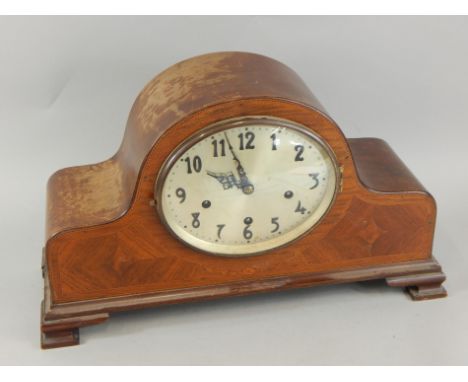 An early 20thC mahogany and marquetry mantel clock, the oval dial with Arabic numerals, with Westminster chime, 49cm wide