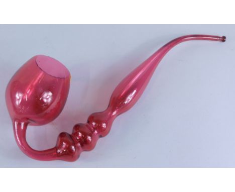 A late 19thC/early 20thC cranberry tinted ornamental pipe, 43cm long.