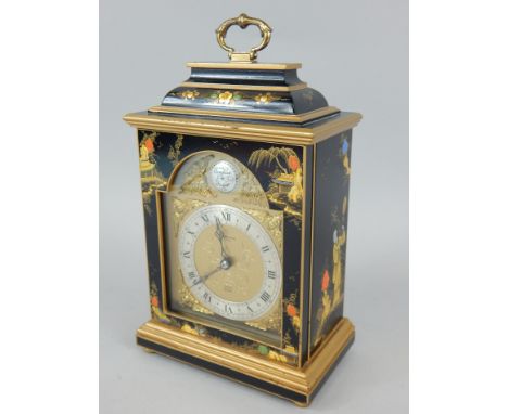 A Japanned bracket clock made by Elliott of London, with a brass handle, 28cm high