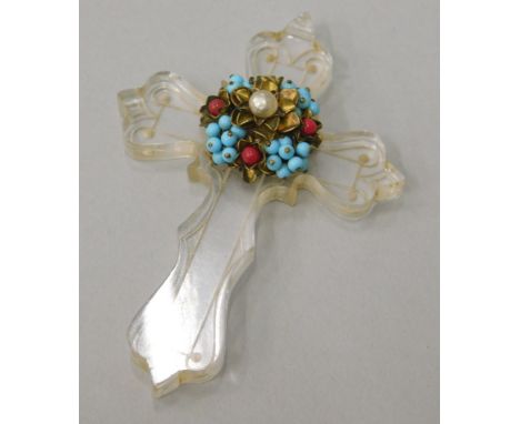 A crucifix, with central attached multi coloured beads and pearl effect centre, the clear crucifix with engraved border desig