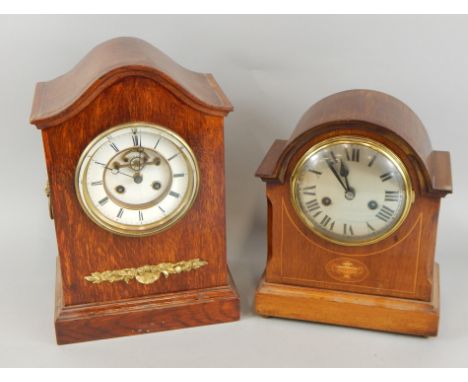 Two similar early 20thC mahogany and oak mantel clocks, one with a silvered dial, the other with a white enamel dial, the lar