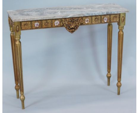 A Continental gilt console table, with a variegated marble top, the frieze applied with Limoges porcelain roundels, on turned