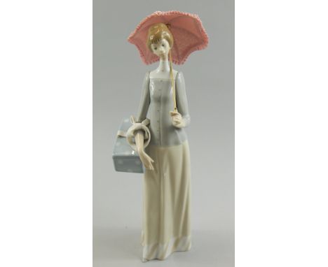 A Lladro porcelain figure of a lady carrying a parasol, 37cm high