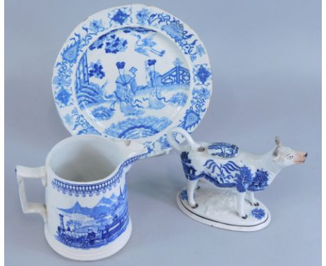 A collection of 19thC ceramics, to include a jug decorated with an early steam engine, printed in blue, a cow creamer printed