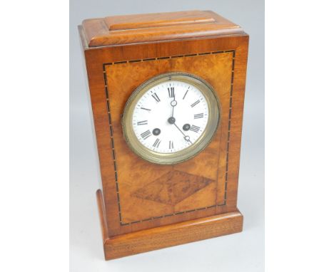 An early 20thC mahogany mantel clock, in burr walnut and checker banded case, the white enamel dial with Roman numerals, the 