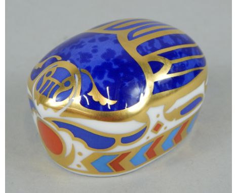 A Royal Crown Derby porcelain millenium bug, printed mark in red to underside and gold button