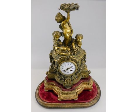 Aubert and Klaftenberger, GenevA  A mid 19thC ormolu mantel clock, mounted with three putti above a blue and white enamel dia