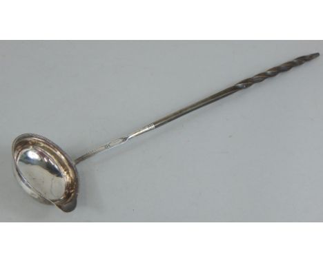 An early 19thC silver toddy ladle, engraved MP to the underside of the bowl, with whale bone handle, 36cm long