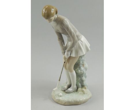 A Lladro porcelain figure modelled in the form of a female golfer, 28cm high