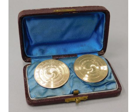 A pair of cufflinks, of large circular engine turned design, on silver backs with gold gilding to front, bearing initials to 