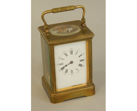 A French brass carriage timepiece, the white enamel dial with Roman numerals, the movement stamped DC, Paris make, 17cm high