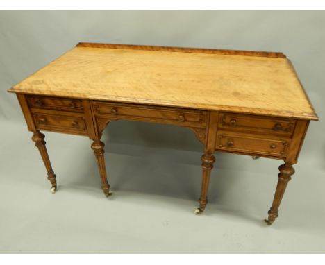 A Victorian satin birch dressing table by W. Bertram of London, the rectangular top with a mould edge above a frieze drawer, 