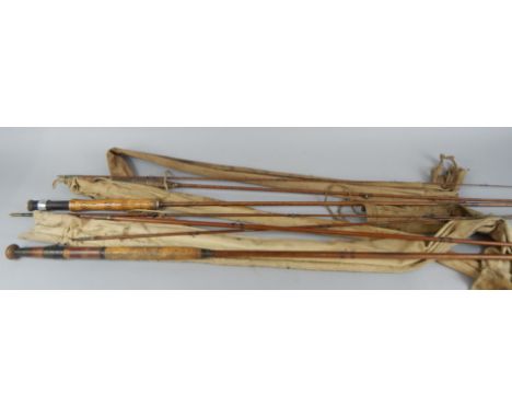 Three vintage fishing rods, each in a canvas bag
