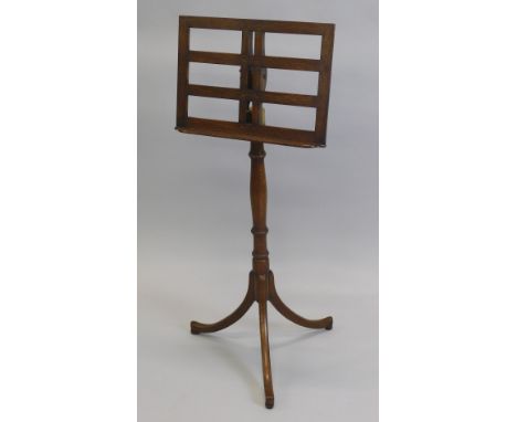 An oak adjustable music stand, with a brass fitting, turned column and tripod base, made by George Hancock, 108cm high